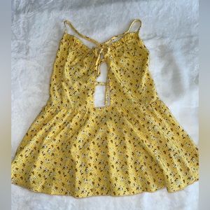 Yellow peplum shirt with cut out in the middle. Size medium.